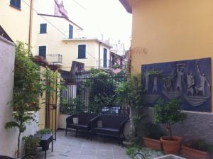 une cour avec des chaises et des plantes en pot à côté d'un bâtiment dans l'établissement Affittacamere Monterosso 5 Terre, à Monterosso al Mare