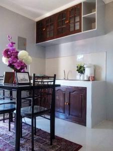 a kitchen with a table with chairs and a sink at LP Madriaga Private Apt fully furnished w/Balcony in Ayusan Norte