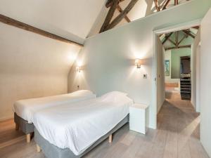 um quarto com uma cama branca num quarto em Holiday Home in Beernem with Shared Sauna em Beernem
