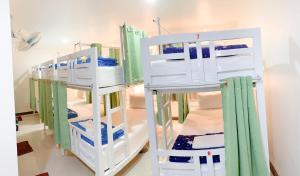 two sets of bunk beds in a room at Lomluang hostel&hotel in Nan
