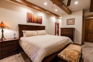 a bedroom with a large bed and a dresser at Villa Cortina 130 in Vail Village in Vail
