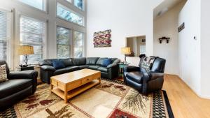 a living room with couches and a table and chairs at Snowcreek #840 condo in Mammoth Lakes