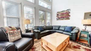 a living room with couches and a table at Snowcreek #840 condo in Mammoth Lakes