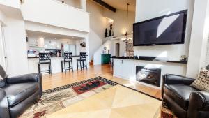 a living room with a fireplace and a flat screen tv at Snowcreek #840 condo in Mammoth Lakes