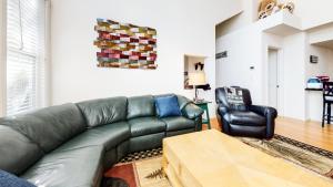 a living room with a leather couch and a chair at Snowcreek #840 condo in Mammoth Lakes +38 photos