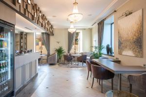 a restaurant with a bar and tables and chairs at CALVARY Hotel & Restaurant Vilnius in Vilnius