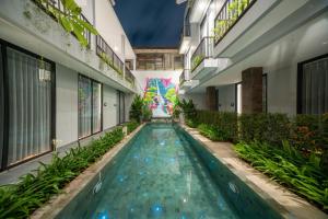 a swimming pool in the middle of a building at Bestah Coliving in Sanur