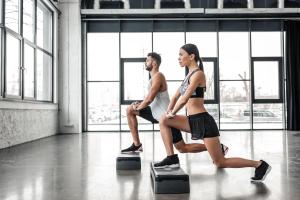 a man and a woman exercising in a gym at Jumeirah Beach Hotel Dubai in Dubai