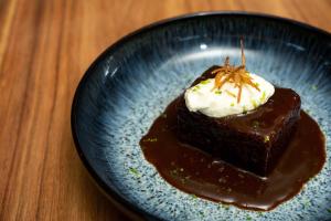 a piece of chocolate cake on a blue plate at Upendo Beach Boutique Hotel Zanzibar in Michamvi