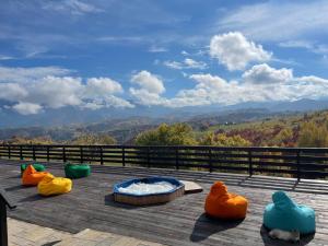 een hot tub op een terras met uitzicht op de bergen bij Pensiunea Casa Boiereasca in Peştera