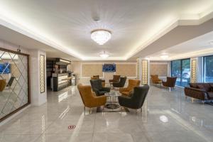 a lobby with couches and a table and chairs at TAMARA Business Otel in Antalya