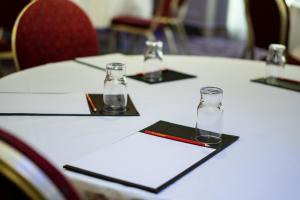 a table with four glasses on top of it at Seagoe Hotel in Portadown