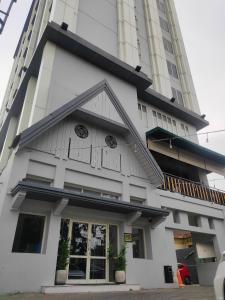 a building in front of a tall building at BATIQA Hotel Darmo - Surabaya in Surabaya