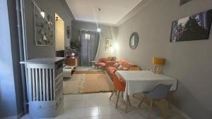 a living room with a table and a couch at Appartement au centre de Nice in Nice