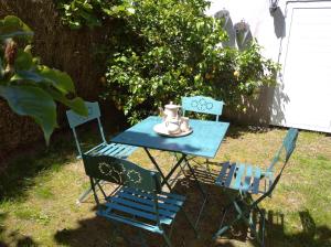 a blue table with two chairs and a tea kettle on it at Casa Raposeira in Ourense