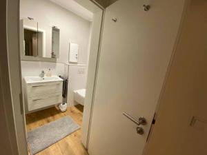 a white bathroom with a sink and a toilet at Ferienwohnungen Bergnest Winterberg in Winterberg +39 photos