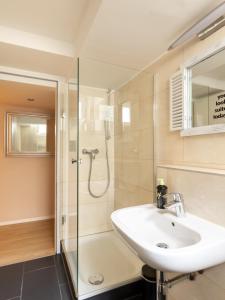 a bathroom with a sink and a shower at limehome Berlin Florastraße in Berlin