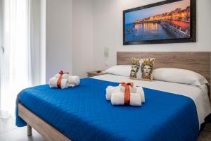 a bedroom with two beds with towels on them at White Apartments & Spa in Avola +216 photos