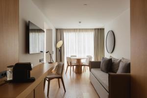 a living room with a couch and a table at Lumen Hotel & The Lisbon Light Show in Lisbon