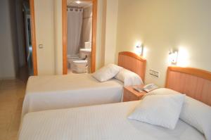 Postel nebo postele na pokoji v ubytování Hostal El Retiro