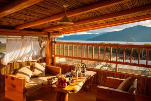 a room with a couch and a table on a balcony at Aurora Hotel in Shangri-La