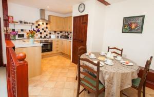 a kitchen with a table and chairs and a kitchen with a table and a table at East Briscoe Farm Cottages in Barnard Castle +21 photos