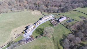 an aerial view of a house in a field at East Briscoe Farm Cottages in Barnard Castle