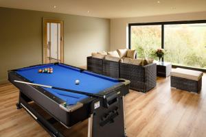 a living room with a pool table in it at East Briscoe Farm Cottages in Barnard Castle