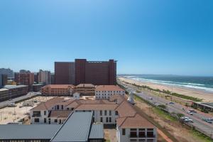 a view of a city with a beach and buildings at Lancaster Gate Apartment in Durban