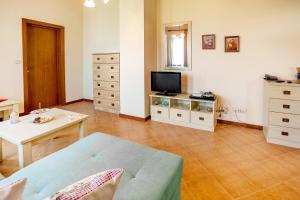 a living room with a couch and a tv at Mountain View Pirin Golf in Bansko