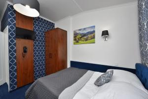 彼得庫夫特雷布納爾斯基的住宿－Hotel AGAT，一间卧室配有一张蓝色和白色的床