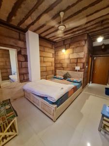 a bedroom with two beds in a room with wooden walls at Gopal Home Stay & Guest House in Jodhpur