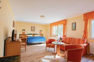 a bedroom with a bed and a living room at Hotel Dünenschloss in Ostseebad Karlshagen