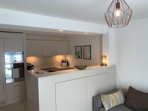 a kitchen with white cabinets and a counter top at Zürich Niederdorf - Grossmünster in Zurich