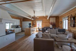 a living room with couches and a table and a kitchen at Saaristohotelli Vaihela in Velkua
