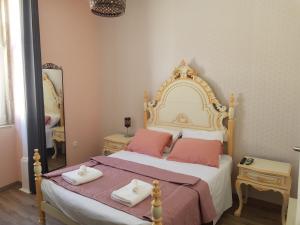 um quarto com uma cama grande e almofadas cor-de-rosa em Garden Place Alojamento Local em Viseu