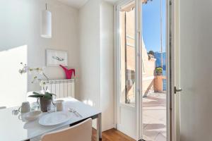 a bathroom with a sink and a table with a mirror at Cadenabbia Lake side Apartments in Griante Cadenabbia +173 photos