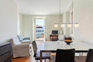 a dining room and living room with a table and chairs at Cadenabbia Lake side Apartments in Griante Cadenabbia