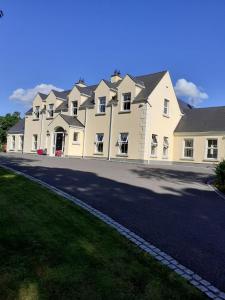 a large white house with a large driveway at Private Room in Superb House Bed 1 in Nobber