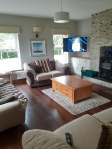 a living room with a couch and a coffee table at Private Room in Superb House Bed 1 in Nobber