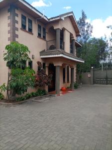 a large house with a driveway in front of it at Palm Airport Suites in Nairobi