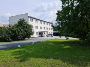 a white building with a car parked in front of it at Ubytování Barborka in Olomouc