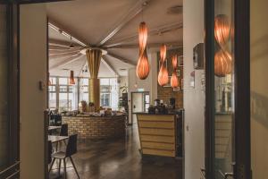 a dining room with lights hanging from the ceiling at The More Hotel Mazetti in Malmö