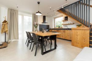 a kitchen and dining room with a wooden table and chairs at Katlov Homes in Červené Janovice
