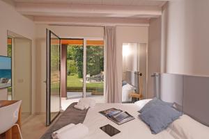 a bedroom with a bed with a view of the ocean at Lamasu RioVerde - Lago di Garda in San Felice del Benaco