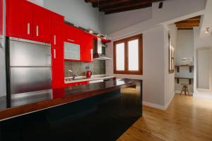 a kitchen with a stainless steel refrigerator and wood cabinets at Top2Stay Málaga in Málaga