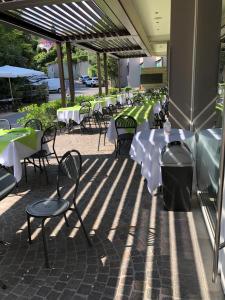 a row of tables and chairs on a patio at Lamasu RioVerde - Lago di Garda in San Felice del Benaco