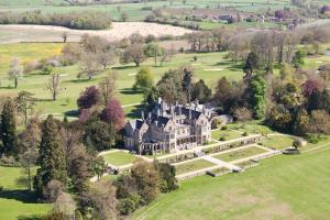 an aerial view of a large mansion with trees at Orchardleigh Estate in Frome