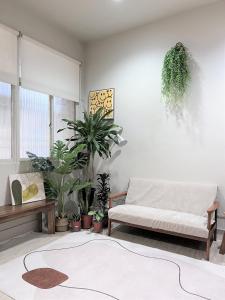 a living room with a couch and potted plants at 微趣 WeChill in Tainan