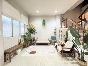 a living room with plants and a staircase at 微趣 WeChill in Tainan